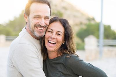 An image of a middle aged couple smiling in Erina after a surgical orthodontic