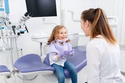 child in the clinic for early dental prevention of cavities